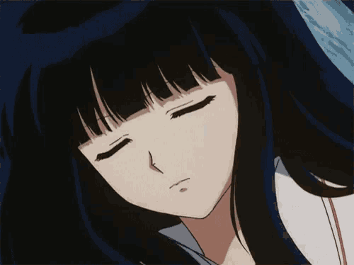 a close up of a girl with her eyes closed .