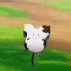 a white cow with black spots is standing on a green field .