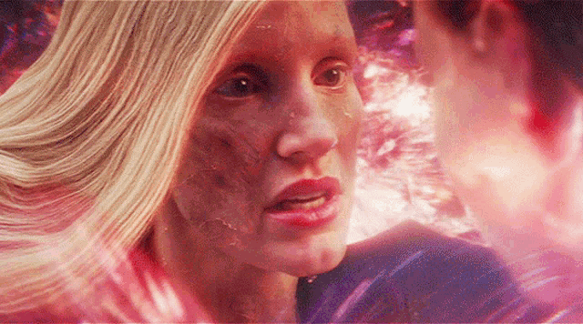 a woman with a scar on her face looks at a man