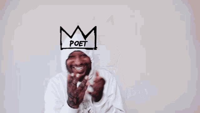 a man wearing a white hoodie with a drawing of a crown on his head with the word poet written on it
