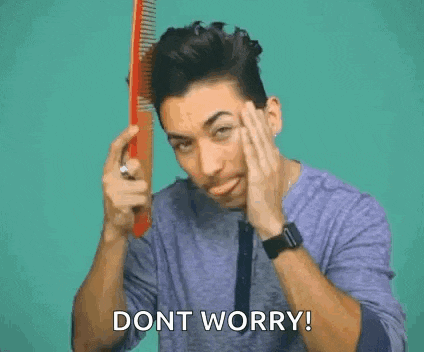 a man is looking at his hair in a mirror and saying `` dont worry '' .