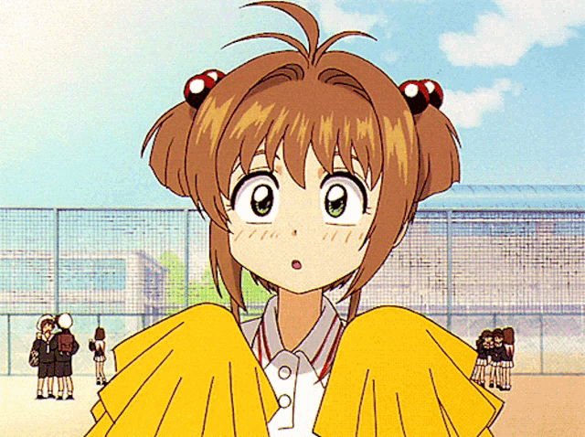 a girl in a yellow cheerleading outfit stands in front of a group of girls