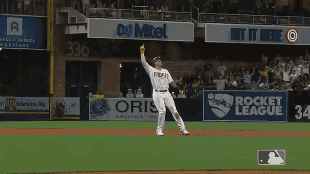 a padres baseball player is giving a thumbs up in front of a crowd .