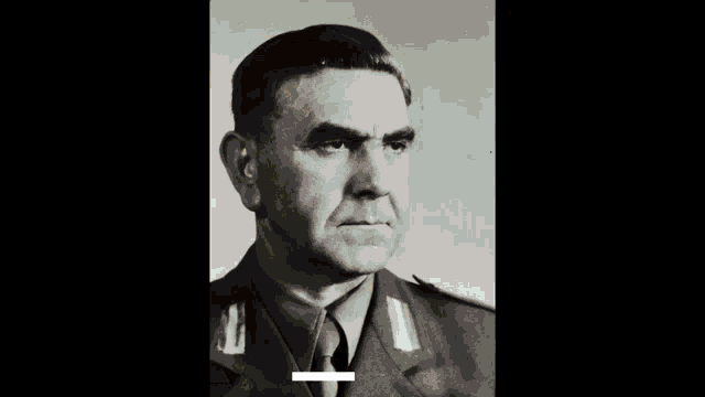 a black and white photo of a man in a military uniform with a pink block in the corner