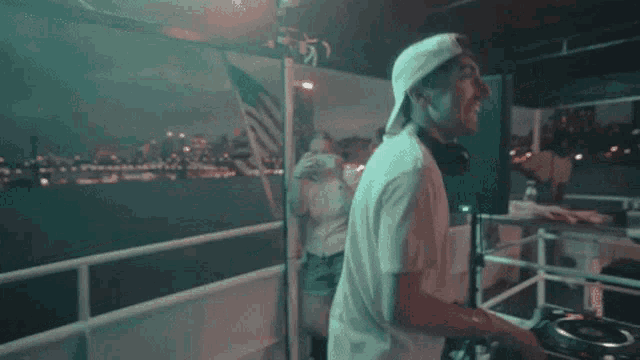 a man wearing headphones is playing music on a deck
