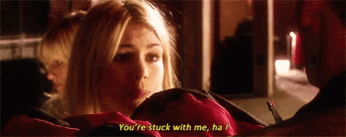 a woman is talking to a man and says you 're stuck with me