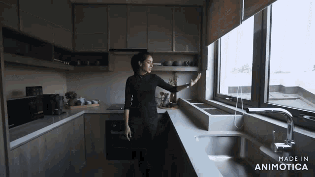 a woman in a kitchen with the words made in animotica on the bottom right