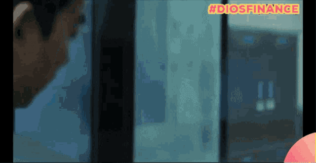 a man is looking at a computer screen with the hashtag #diosfinance