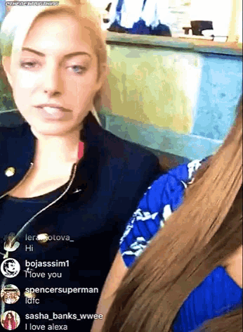 a woman in a black jacket is sitting next to another woman in a blue shirt ..