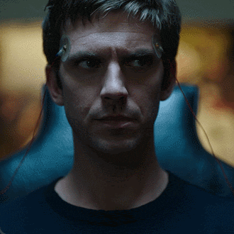 a close up of a man 's face with wires coming out of his ear