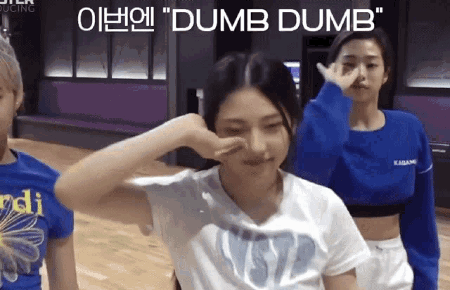 a girl in a white shirt is making a dumb dumb sign