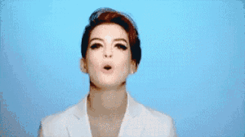 a pixelated image of a woman in a white jacket against a blue background