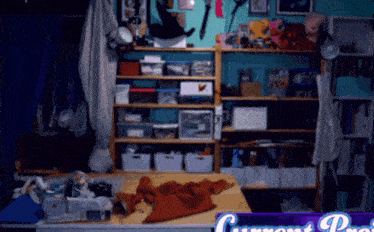 a cluttered room with a sign that says current project on it