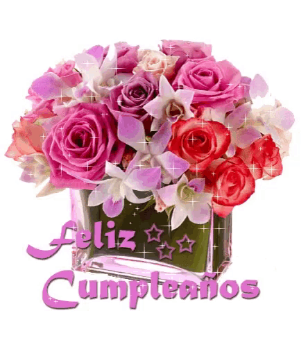 a bouquet of pink roses and orchids in a vase with the words feliz cumpleanos on the bottom
