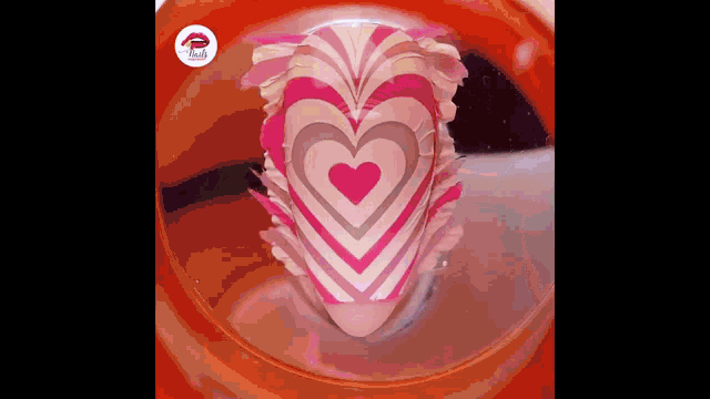 a close up of a heart shaped cake in a glass