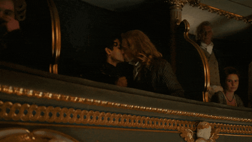 a man and a woman kissing in a dark room