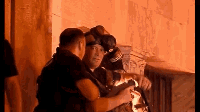 a group of men are standing next to each other in a room .