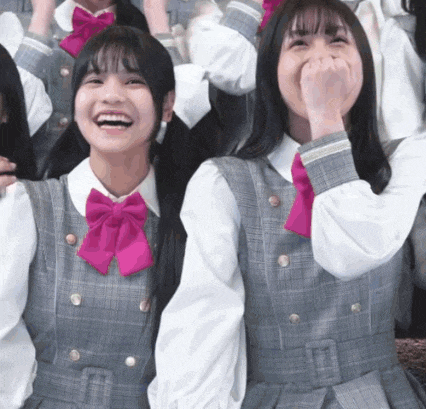a girl wearing a pink bow tie is laughing