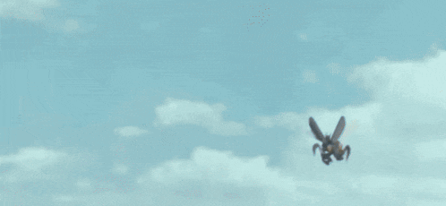 a blurred image of a person 's face with a blue sky in the background