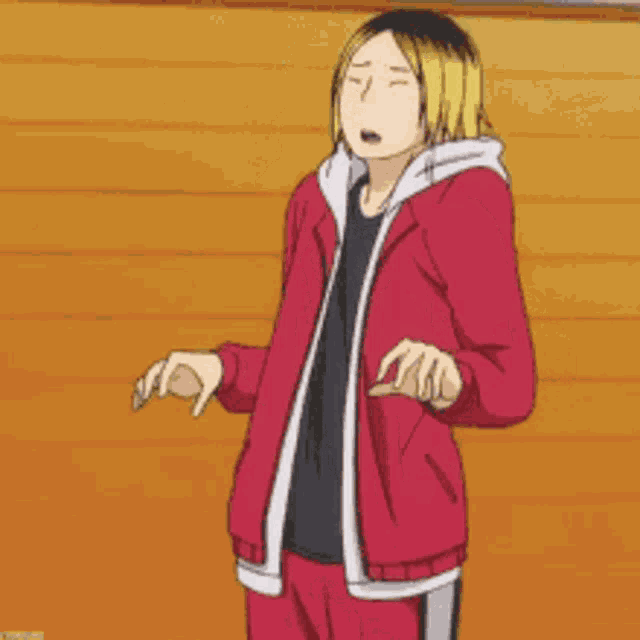 a man in a red jacket and yellow hair is standing on a wooden floor .