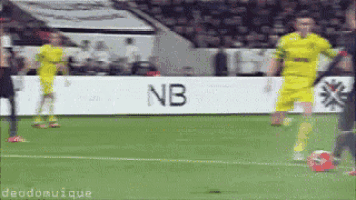 soccer players on a field with a sign that says nb on it