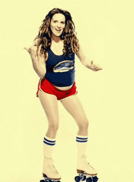 a woman wearing roller skates and a blue tank top with a penguin on it