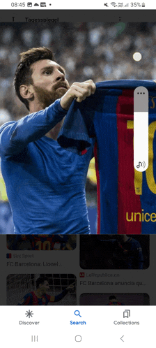 a phone screen shows a soccer player holding up a jersey that says unicef