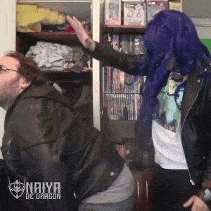 a man in a black jacket is being spanked by a woman in a blue wig