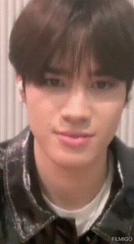 a close up of a young man 's face with a grid pattern .