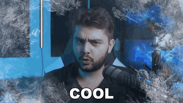 a man with a beard stands in front of a microphone with the word cool written below him