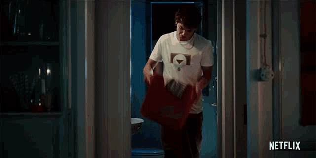 a man is standing in front of a red box that says netflix