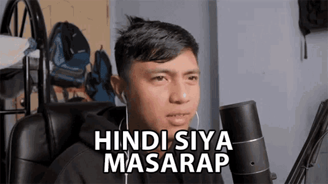 a man sitting in front of a microphone with the words hindi siya masarap above him