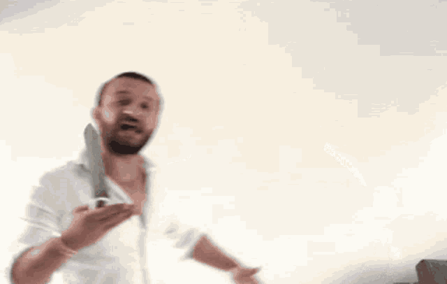 a man with a beard is holding a large knife