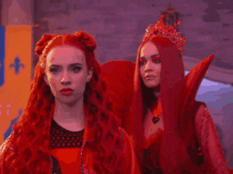 two women with long red hair are standing next to each other in a room .