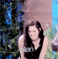 a woman is smiling in front of a tree and the word ellen is on the bottom