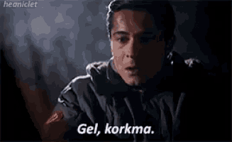 a man is talking to another man in a dark room and says `` gel , korkma '' .