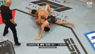 two men are wrestling on a ufc ring and the time is 2:28