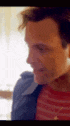 a close up of a man 's face with a blurred background .