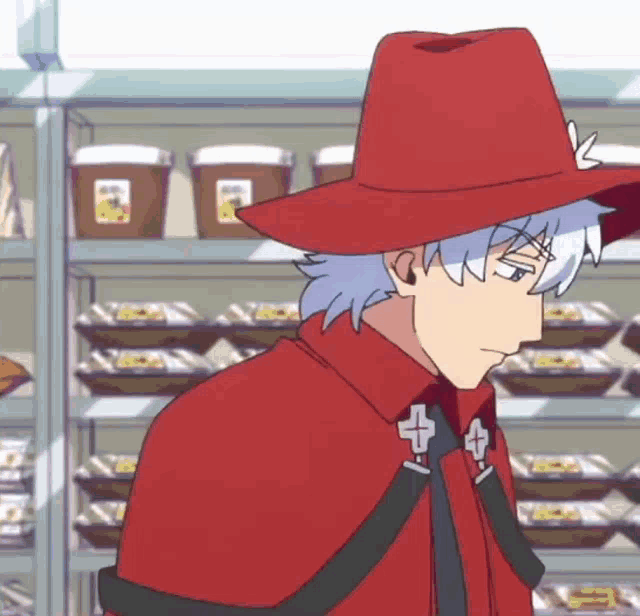 a man in a red hat and cape is standing in front of shelves of food