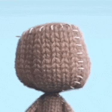 a close up of a stuffed animal with stitches on it 's head