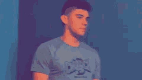a blurry picture of a man in a blue shirt