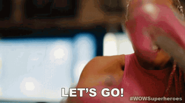a woman wearing pink boxing gloves says " let 's go "