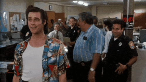 a man in a hawaiian shirt is standing in front of a sign that says " to keep off "