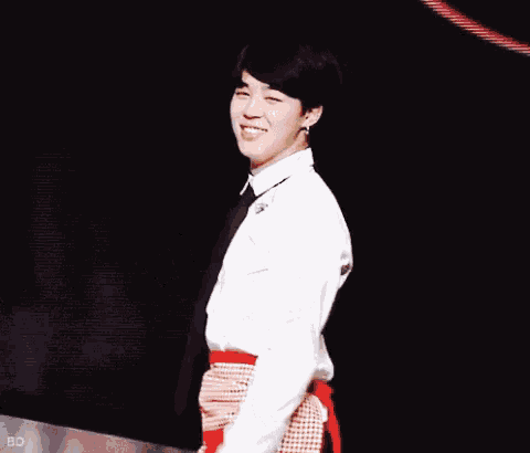 a man wearing white gloves and a white shirt is making a peace sign