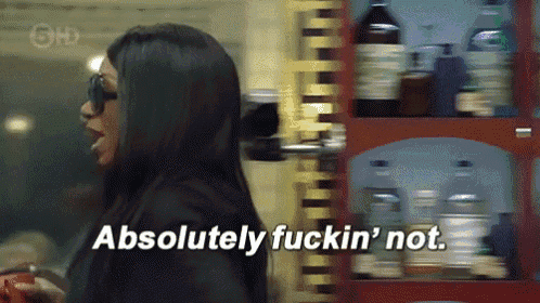 a woman in sunglasses says absolutely fuckin ' not in front of a shelf full of bottles
