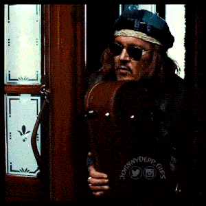 a man wearing sunglasses and a hat has a johnny depp logo on his jacket