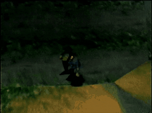 a video game character is standing on a sandy surface .