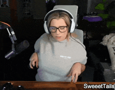 a woman wearing headphones and a sweatshirt that says white fox paris