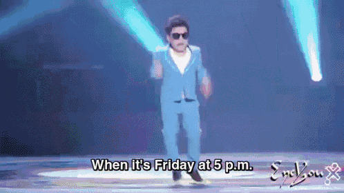 a man in a blue suit is dancing on a stage with the words when it 's friday at 5 pm