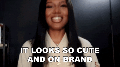 a woman with long black hair is smiling and says it looks so cute and on brand .